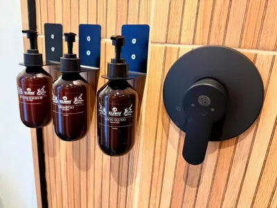 three bottles of alcohol are attached to a wall at Lujoso y cómodo Loft en Laureles in Medellín