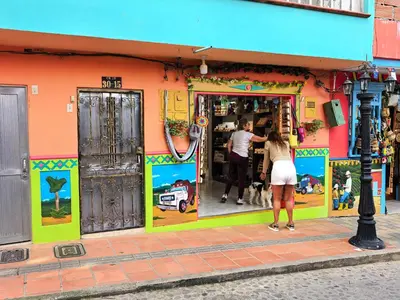 a man and a woman standing outside of a store at La Jaus by Hope in Guatapé