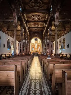 an empty church with wooden pews and a large ceiling at La Jaus by Hope in Guatapé