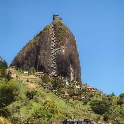 a mountain with a lighthouse on top of it at La Jaus by Hope in Guatapé