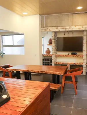 a dining room with a table and a television at Relax Medellín 10ppl 3br 4b Jacuzzi 2,075 sq ft in Medellín
