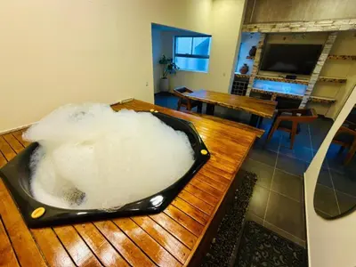 a bath tub filled with snow on top of a wooden table at Relax Medellín 10ppl 3br 4b Jacuzzi 2,075 sq ft in Medellín