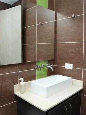 a bathroom with a sink and a mirror at Relax Medellín 10ppl 3br 4b Jacuzzi 2,075 sq ft in Medellín