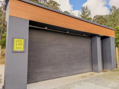 a garage door with a sign in front of it at masion la catedral de pablo con vista a la montaña in Envigado
