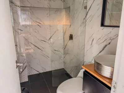 a bathroom with a white toilet and a sink at masion la catedral de pablo con vista a la montaña in Envigado