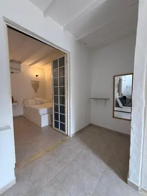 a white room with a bed and a mirror at Cabañas Milos in Doradal