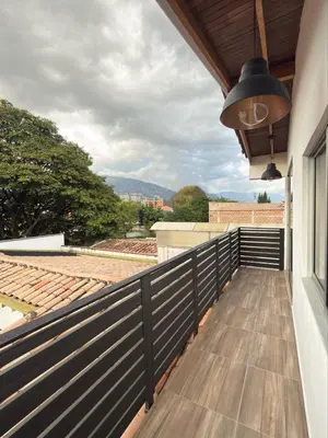 a balcony with a view of a roof at SkyView Medellín 4ppl 1br 1b luxury terrace loft in Medellín