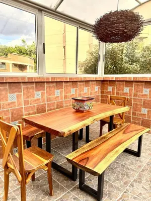 a wooden table and benches on a patio at SkyView Medellín 4ppl 1br 1b luxury terrace loft in Medellín