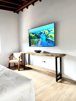 a living room with a tv on a wall at SkyView Medellín 4ppl 1br 1b luxury terrace loft in Medellín