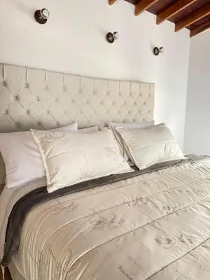 a large bed with a white headboard and white pillows at SkyView Medellín 4ppl 1br 1b luxury terrace loft in Medellín