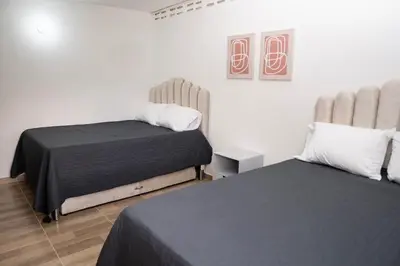 a bedroom with two beds in a room at Newly remodeled house a block away from the park in San Luis
