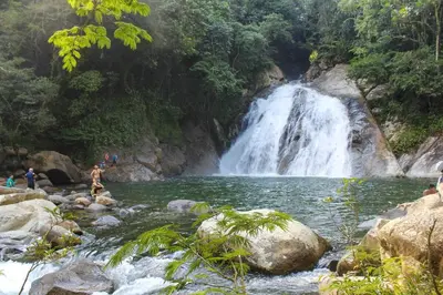 a waterfall in a river with people in front of it at Newly remodeled house a block away from the park in San Luis
