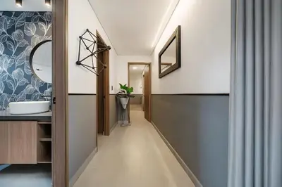 a hallway leading to a bathroom with a sink at Poblado Walkable Loft - Parking Included in Medellín