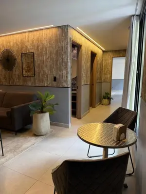 a living room with a table and a couch at Poblado Walkable Loft - Parking Included in Medellín