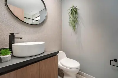 a bathroom with a sink and a toilet and a mirror at Poblado Walkable Loft - Parking Included in Medellín