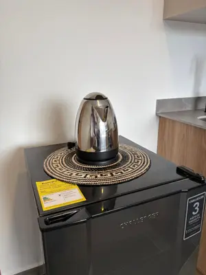 a helmet is sitting on top of a dishwasher at Apartamento Laureles in Medellín