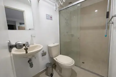 a bathroom with a toilet and a sink and a shower at Loft con balcón y baño Laureles Belén TOP LOCATION in Medellín