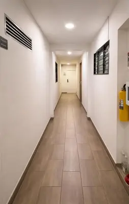 a hallway with white walls and a tile floor at Loft con balcón y baño Laureles Belén TOP LOCATION in Medellín