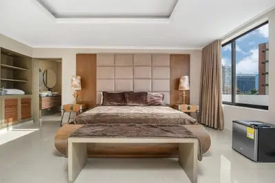 a bedroom with a large bed and a large window at villa poblado in Medellín