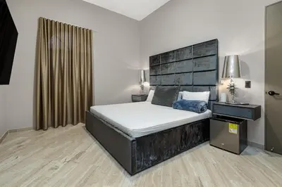 a bedroom with a large bed with a black headboard at villa poblado in Medellín