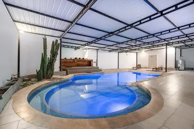 a large pool with blue water in a building at villa poblado in Medellín