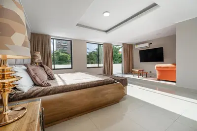 a bedroom with a bed and a flat screen tv at villa poblado in Medellín