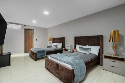 a bedroom with two beds and a flat screen tv at villa poblado in Medellín