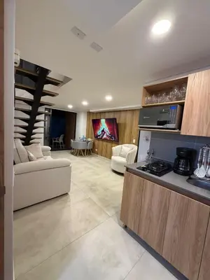 a kitchen and living room with a couch and a table at Loft lujoso en Laureles in Medellín