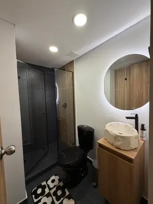 a bathroom with a shower and a toilet and a sink at Loft lujoso en Laureles in Medellín