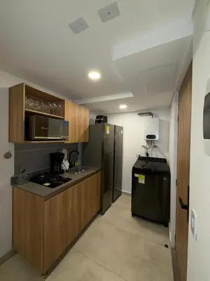 a kitchen with a stove and a refrigerator at Loft lujoso en Laureles in Medellín