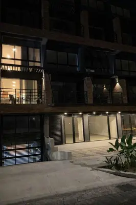 a large building with doors and windows at night at Loft lujoso en Laureles in Medellín