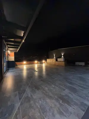 an empty parking lot at night with lights at Loft lujoso en Laureles in Medellín