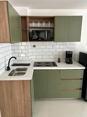 a kitchen with a sink and a microwave at Boho Green Apartment in Medellín
