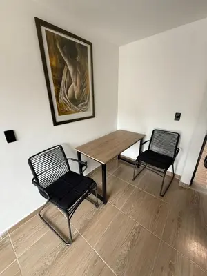 a room with two chairs and a table and a painting at Apartamento moderno balcón, Wifi, Netflix-Rionegro in Rionegro