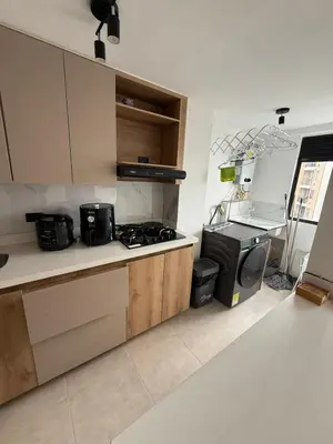 a kitchen with a stove top oven next to a sink at Apartamento moderno balcón, Wifi, Netflix-Rionegro in Rionegro