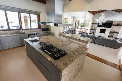 a kitchen with a stove top island in a room at Mansión de lujo La Reina Llanogrande in Rionegro