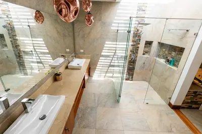 a bathroom with two sinks and a shower at Mansión de lujo La Reina Llanogrande in Rionegro