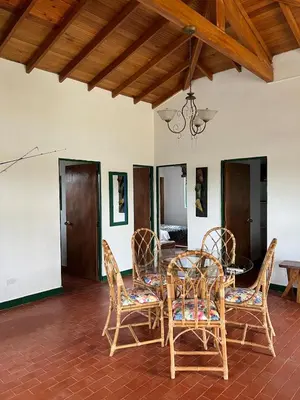a dining room with a table and chairs at Spacious Cabin with Garden and Lake Access, Guatapé in Guatapé
