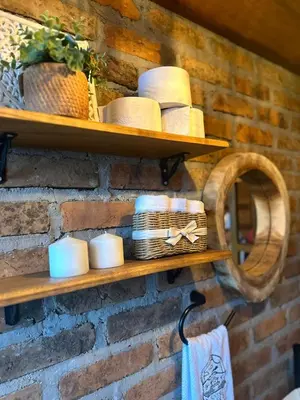 a shelf with hats and cups on a brick wall at EntreNubes Hospedaje de Alta Montaña