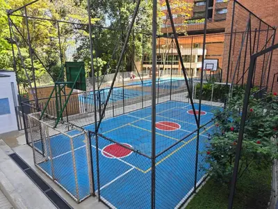 a batting cage around a swimming pool at Modern sky high apartment in La Estrella in La Estrella