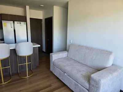 a living room with a couch and a bar at Modern sky high apartment in La Estrella in La Estrella