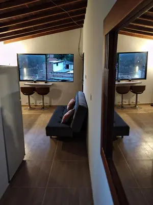 a living room with a couch and two computer monitors at Apartamento Independiente y Completo Gran Ubicación, La 80 Belén in Medellín