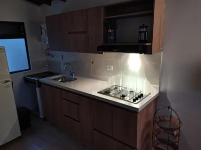 a small kitchen with a sink and a stove at Apartamento Independiente y Completo Gran Ubicación, La 80 Belén in Medellín