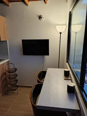 a conference room with a table and a flat screen tv at Apartamento Independiente y Completo Gran Ubicación, La 80 Belén in Medellín