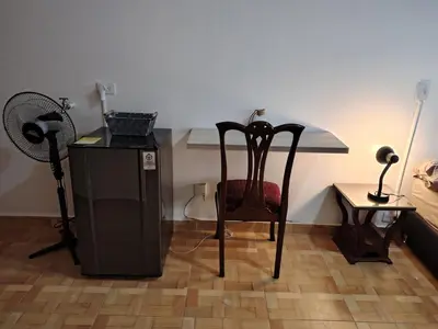 a room with a chair and a desk with a fan at Cómodo Apartamento Independiente Primer Piso - Belén La 80 in Medellín