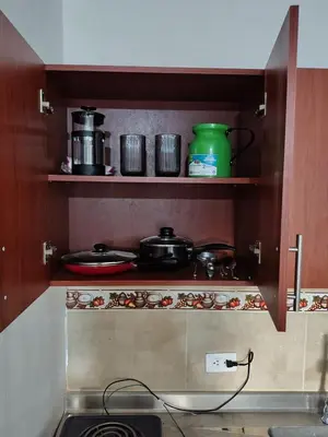 a kitchen with some pots and pans on shelves at Cómodo Apartamento Independiente Primer Piso - Belén La 80 in Medellín