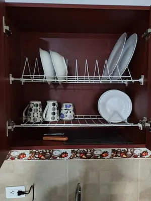 a kitchen with plates and bowls on a shelf at Cómodo Apartamento Independiente Primer Piso - Belén La 80 in Medellín