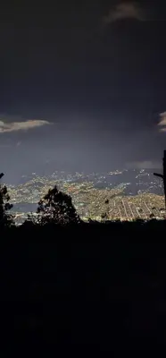 a view of a city from the top of a hill at Glamping Eros in Medellín