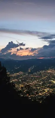 a view of a city at night from a mountain at Glamping Eros in Medellín