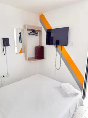 a room with a bed and a flat screen tv at Hotel California Blue Manizales in Manizales
